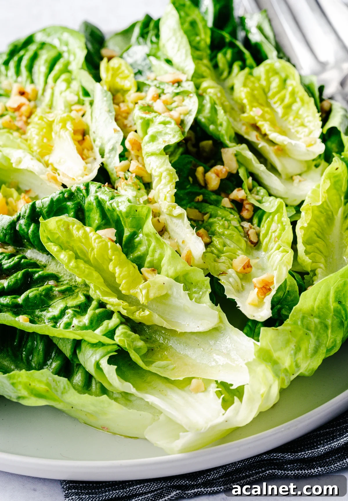 Little Gem Salad served on a round white platter.