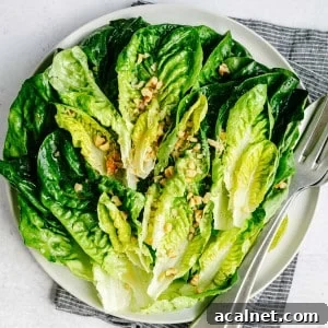 Little Gem Salad served on a round white platter and photographed from overhead.