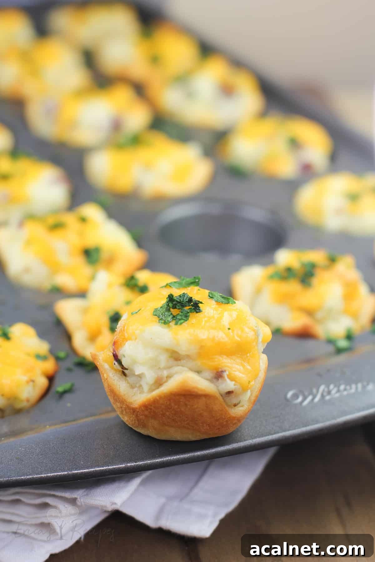 potato cup on the rim of muffin pan