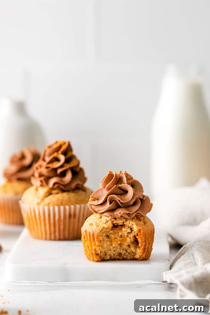Close-up of peanut butter cupcakes with one bite out showing texture.