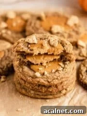 stack of pumpkin cheesecake cookies on parchment paper