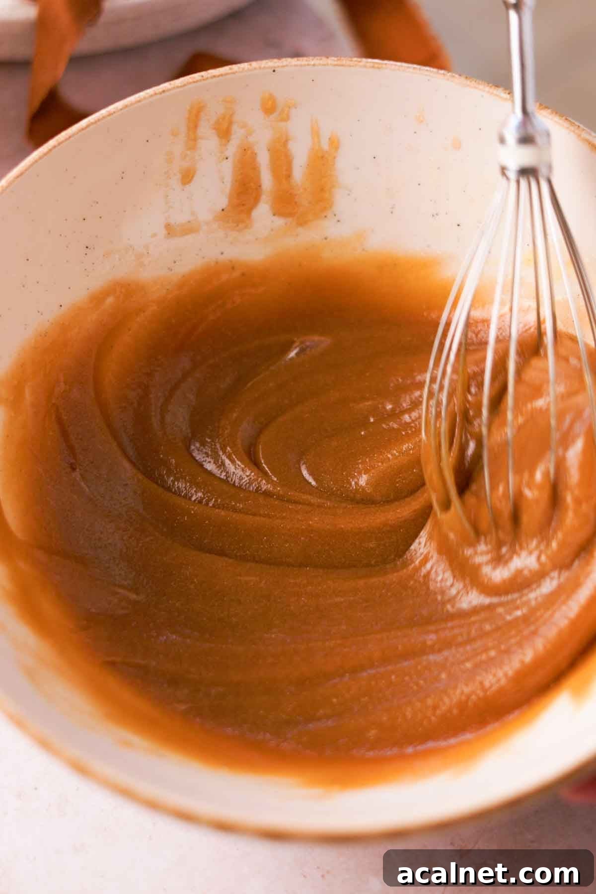 whisking melted butter, sugar, and egg mixture until thick and creamy