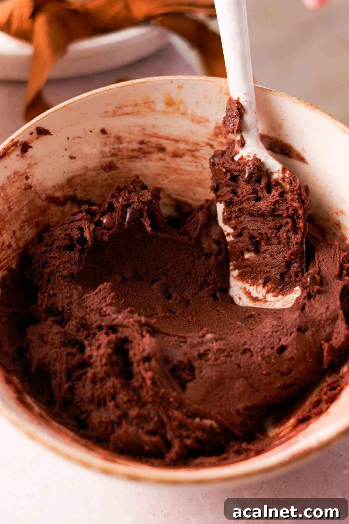 folding chocolate cookie dough with silicone spatula