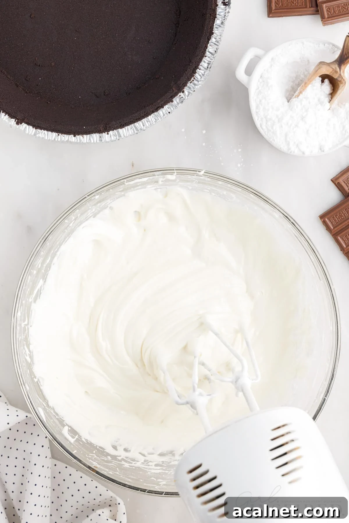 Cream cheese mixture mixed in a bowl with a hand mixer.