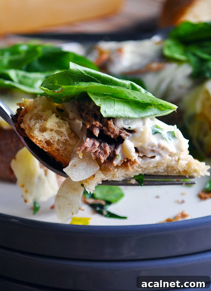 A bite of open face Pot roast sandwich