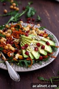 Healthy Sweet Potato Noodle Salad with Chickpeas and Rocket with Lots of Ingredients Around the Plate.