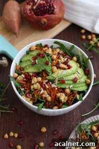 Healthy Sweet Potato Noodle Salad with Chickpeas and Rocket with Pomegranate Seeds Around the Bowl