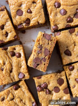 tops of chocolate chip cookie bars with one bar turned on its side to show chocolate chips inside