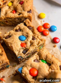 monster cookie bar with m&ms on parchment paper.