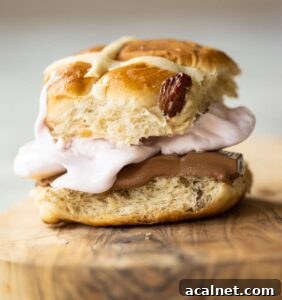 close up shot of smores hot cross bun sandwich on small wooden board