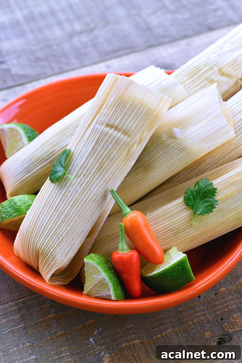 Authentic Chicken Green Chile Tamales Recipe You'll Love 4 24Bite: Beautiful chicken tamales wrapped in corn husks and served with lime cilantro and Thai chiles