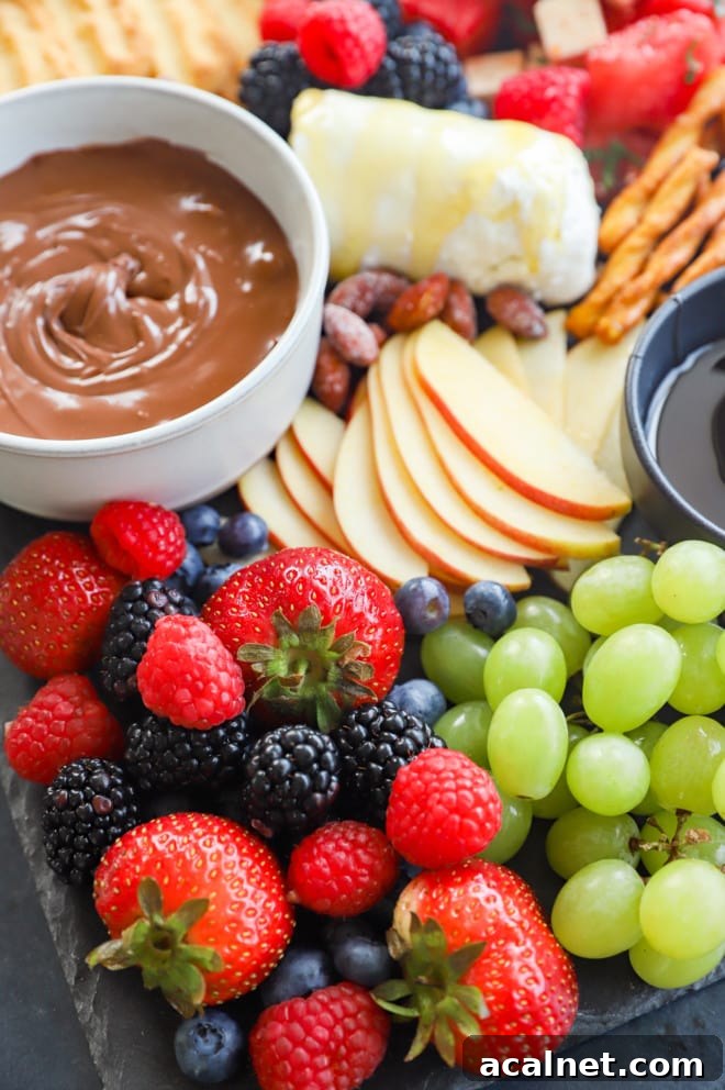 Fresh Fruit Charcuterie Board Ideas for Entertaining 3 Fresh berries, grapes, apples and nutella on a snack tray