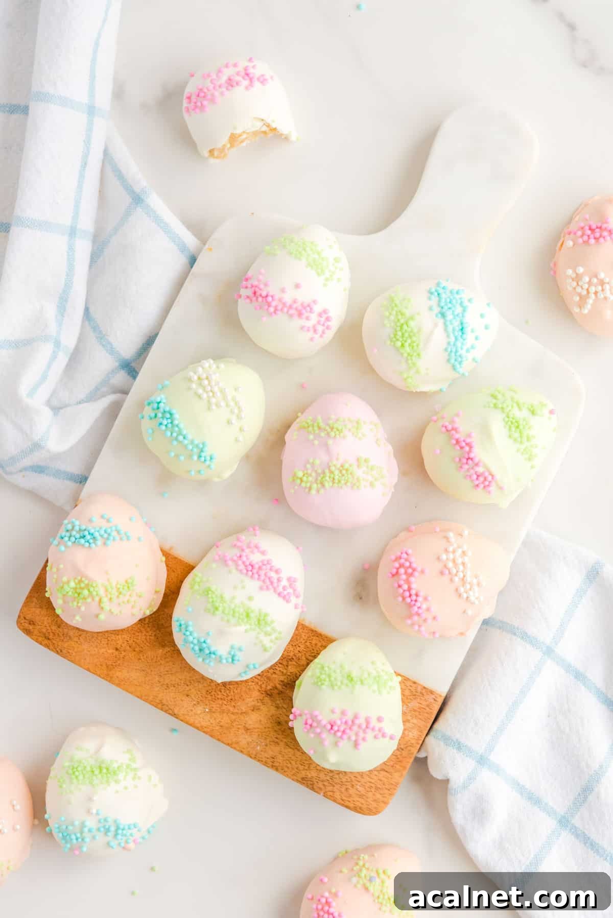 easter egg truffles arranged on and around a cutting board and a kitchen towel