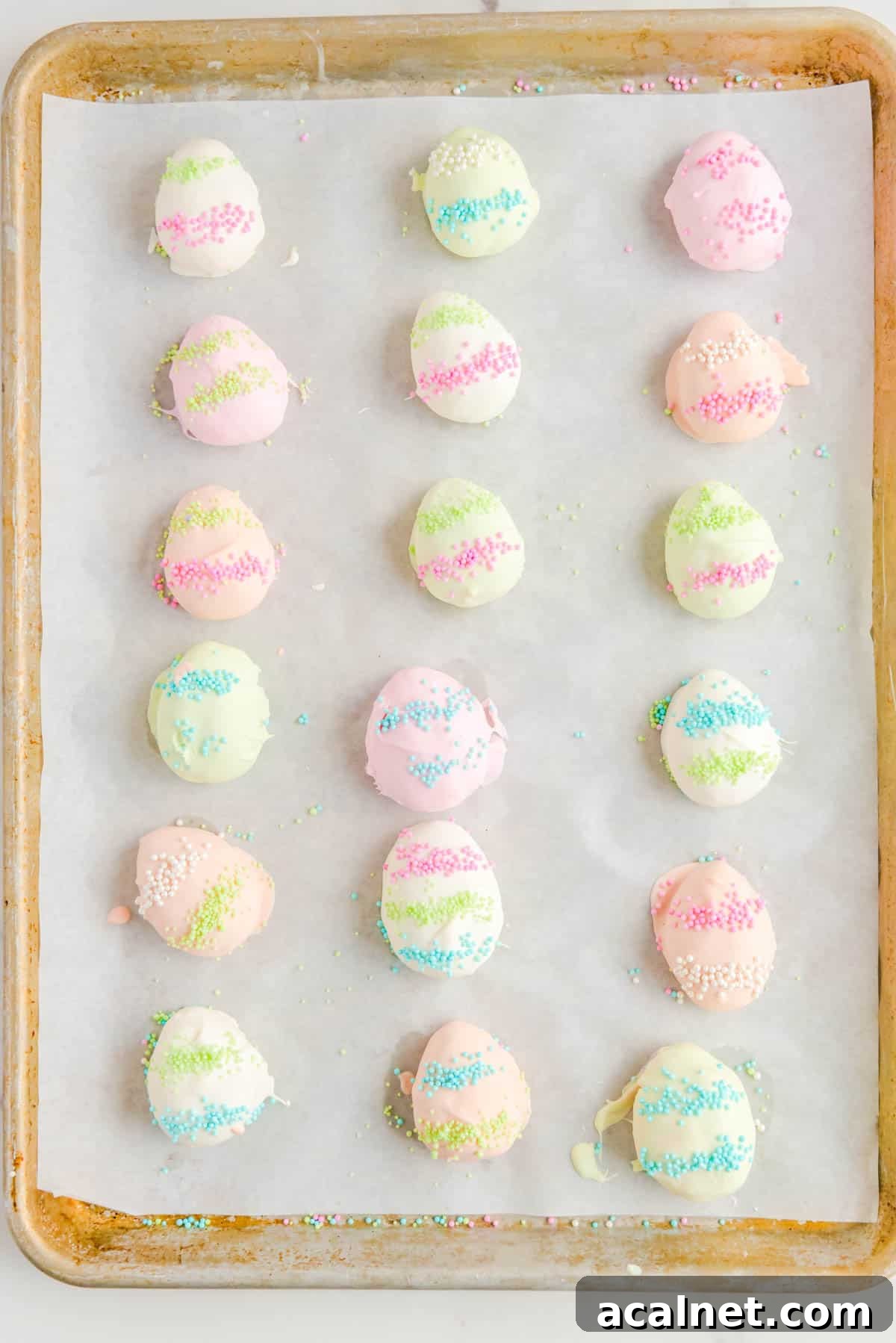 easter egg truffles lined in three columns on a baking sheet