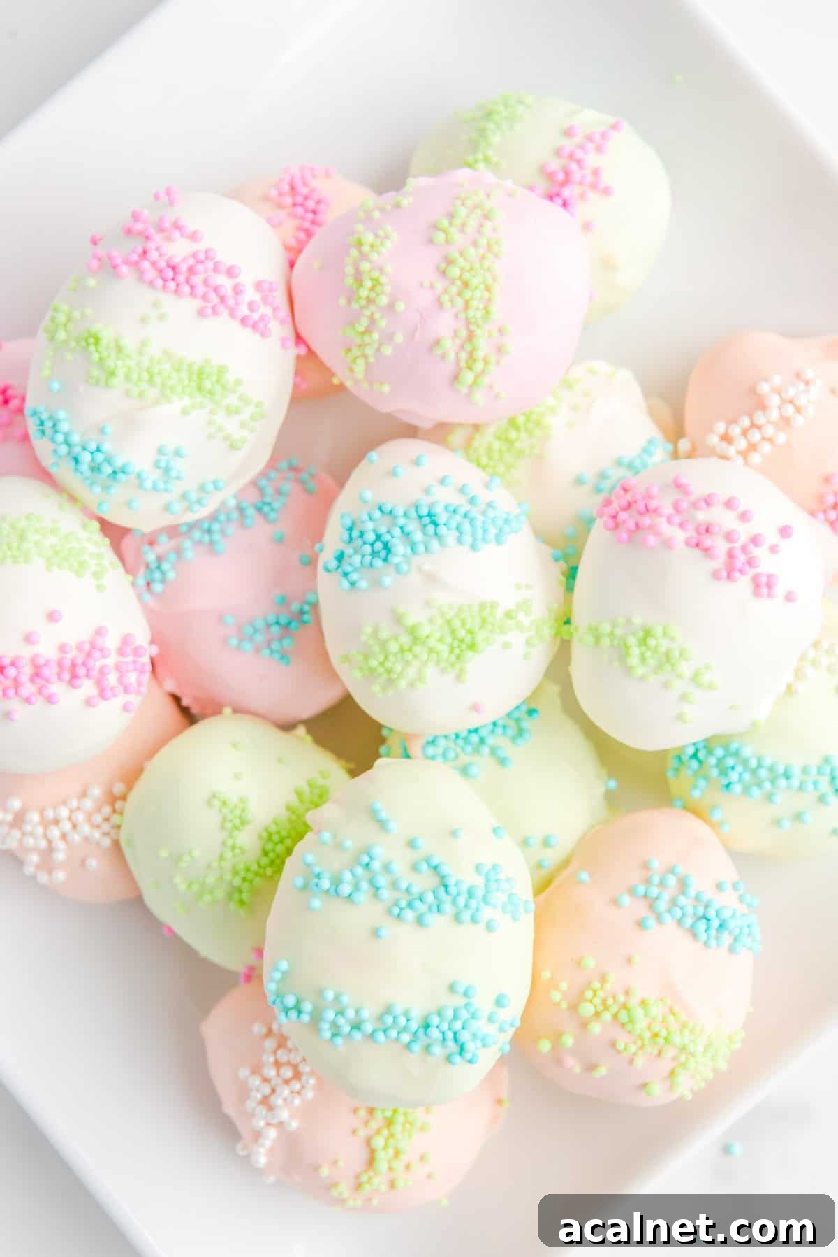a pile of easter egg truffles on a white plate