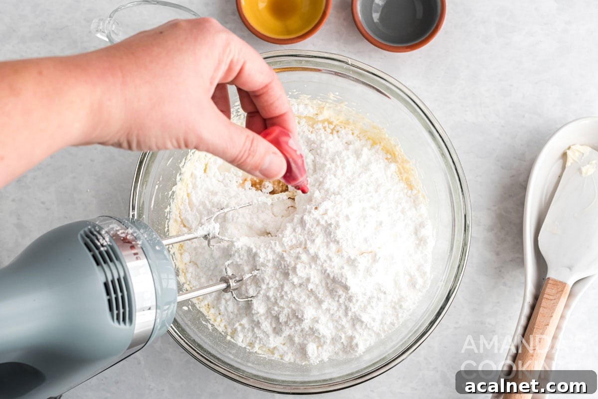 adding food coloring to frosting