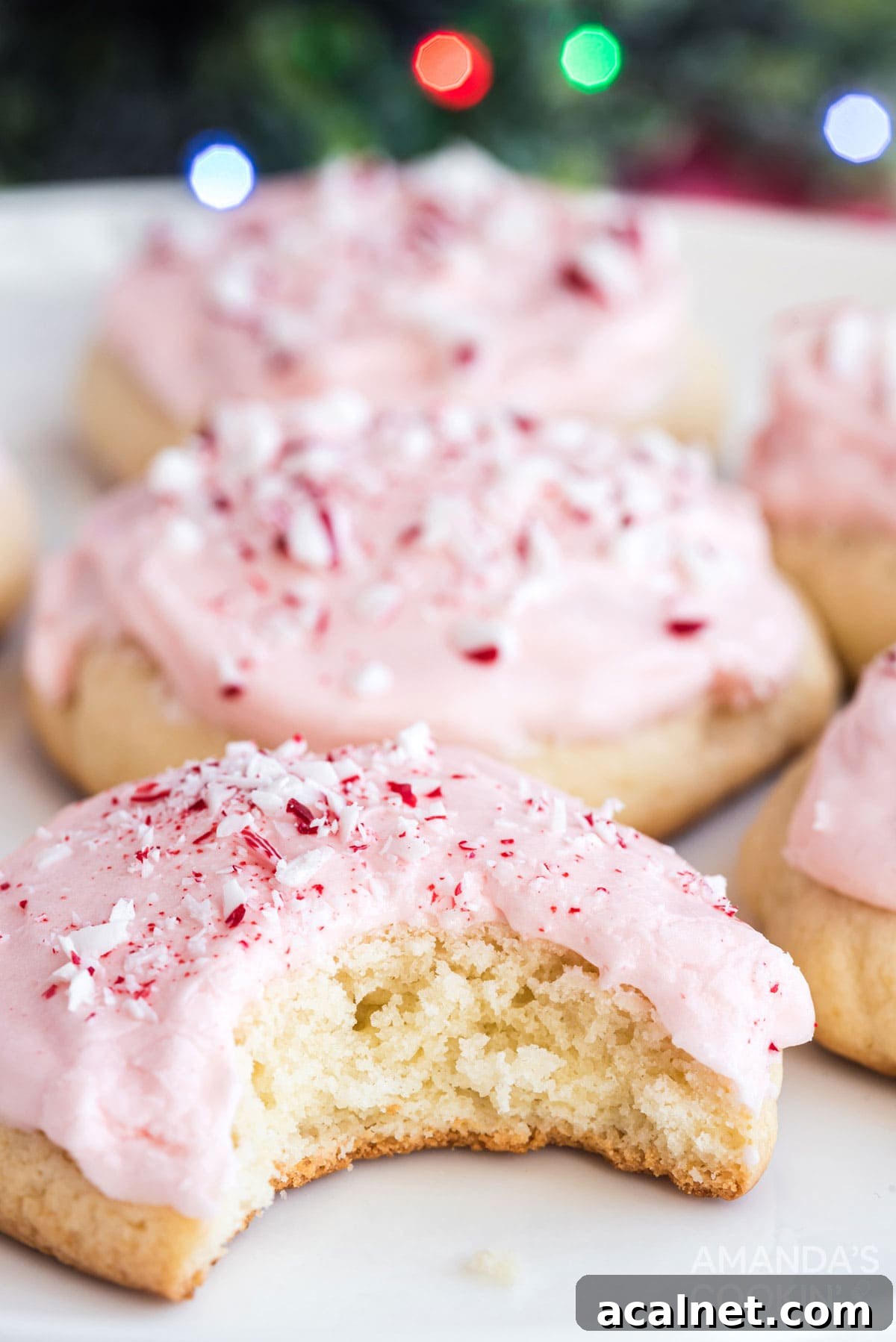 pink frosted peppermint cookie with a bite out of it