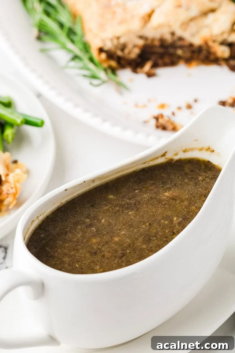 Rich vegan mushroom gravy in a white gravy boat.