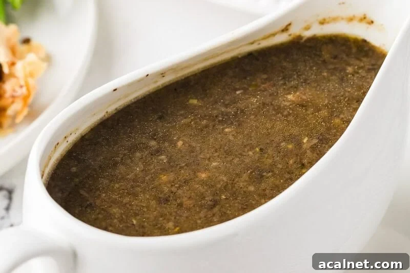 Rich vegan mushroom gravy in a white gravy boat.