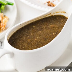 Rich vegan mushroom gravy in a white gravy boat.