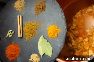 mix of paprika, cumin, allspice, ginger, turmeric and coriander. Plus a cinnamon stick & cardamom pods on a black slate