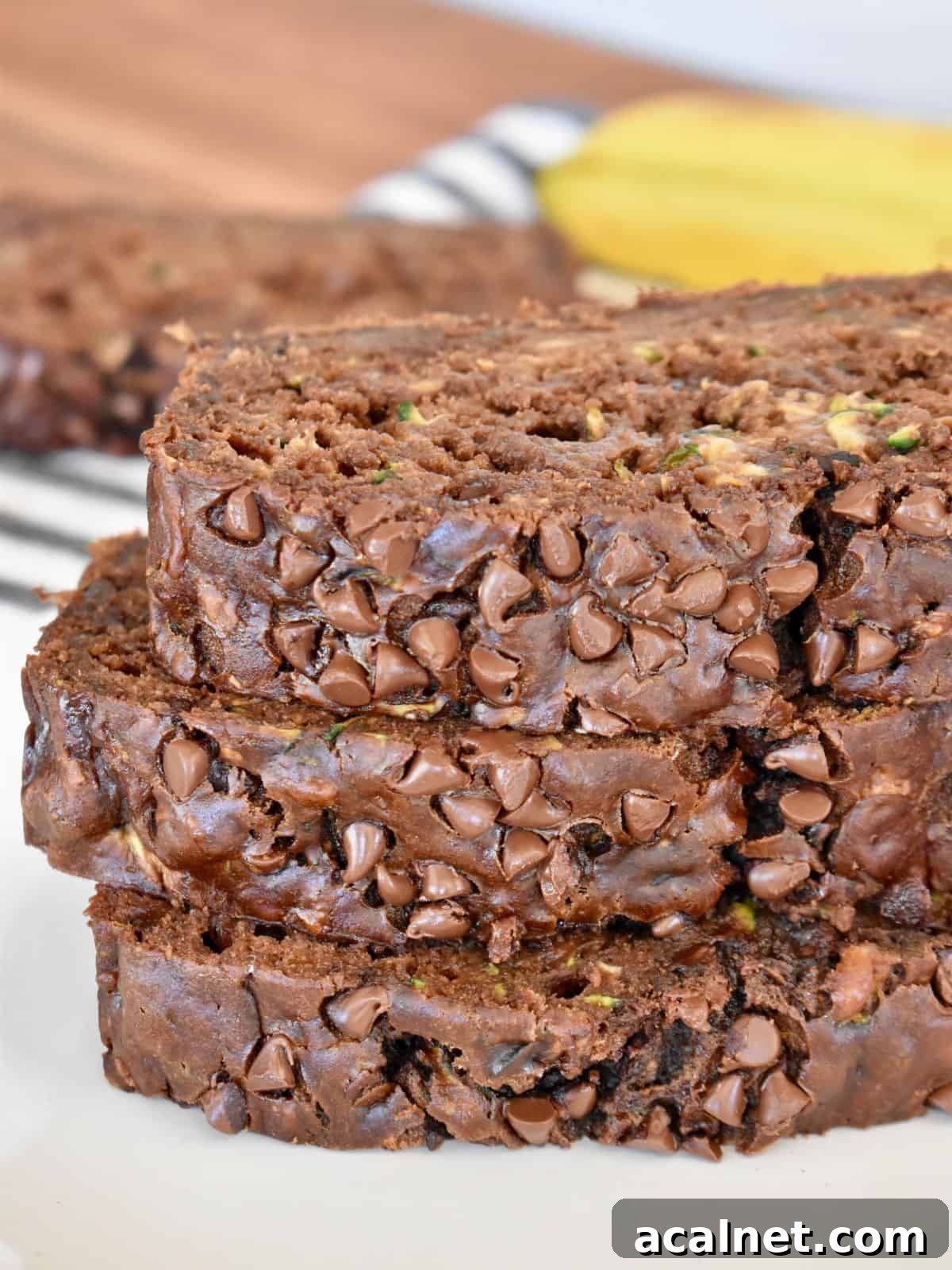 Chocolate Zucchini Banana Bread Recipe: Moist Loaf with Cocoa and Banana 2 Chocolate zucchini banana bread sliced on a white plate.