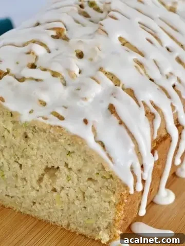 Glazed Zucchini Apple Bread on a wood cutting board.