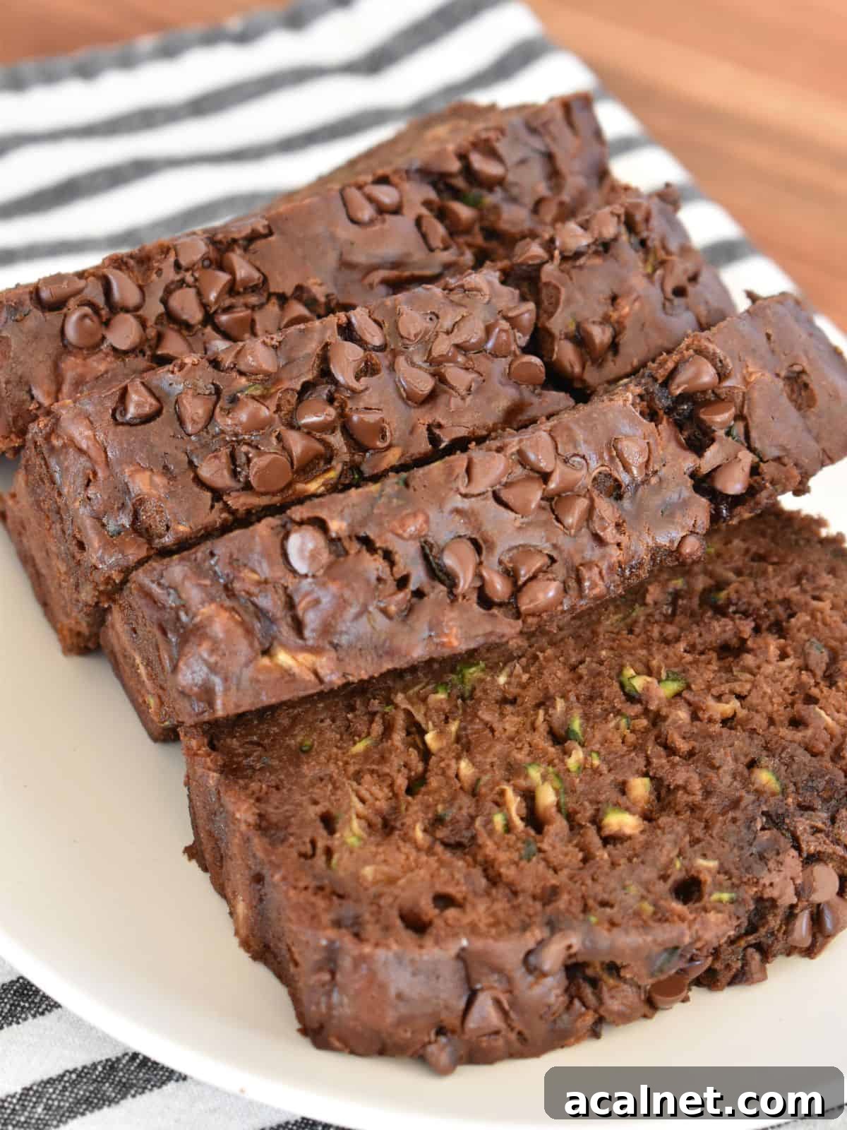 Chocolate Zucchini Banana Bread Recipe: Moist Loaf with Cocoa and Banana 7 Sliced chocolate zucchini banana bread on a white plate.