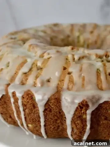 Pineapple Zucchini Cake on a white pedestal.
