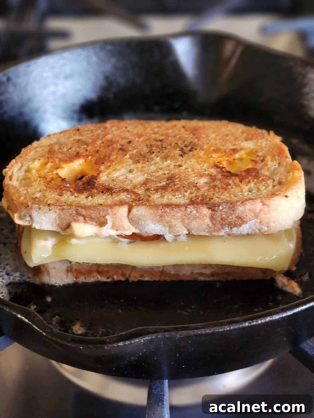 Kielbasa Reuben Sandwich Recipe — Smoky Sausage & Sauerkraut Melt 9 Reuben sandwich grilling in a cast iron skillet.