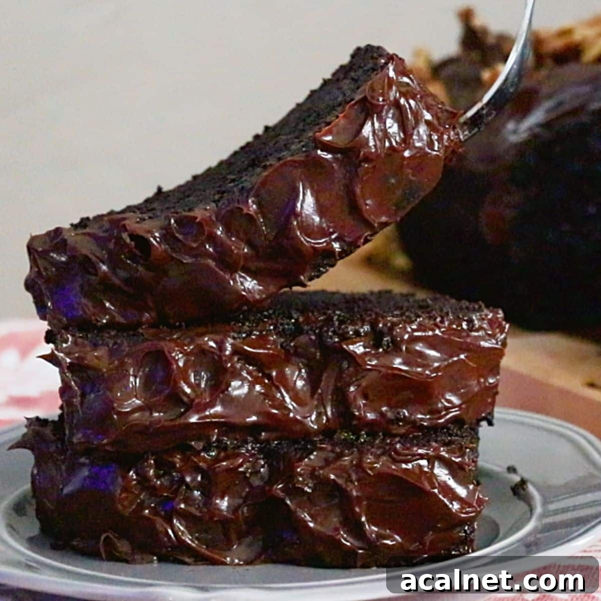 3 slices of moist chocolate banana cake, frosted with ganache cream