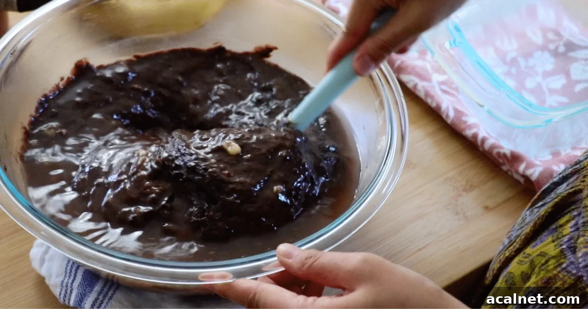 Mixing the hot water into the chocolate banana cake batter.