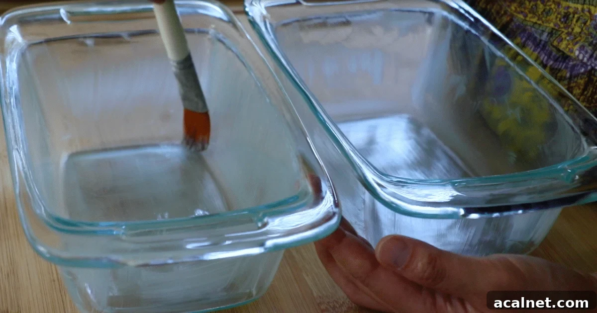 Brushing a thin layer of softened butter inside the pans.