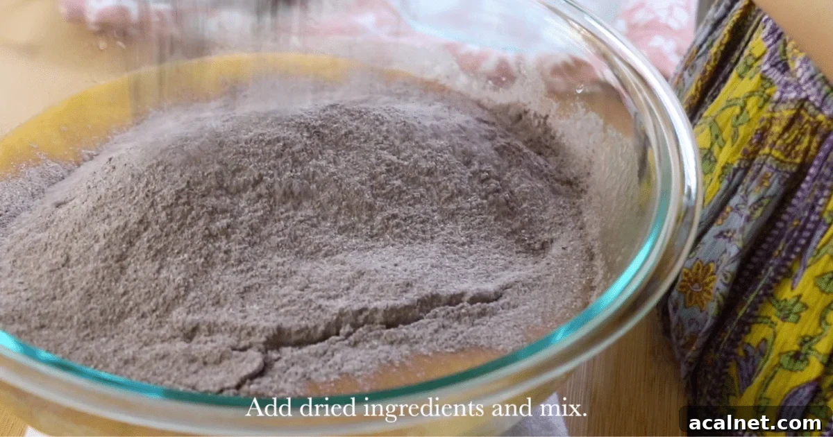 Adding the dry ingredients to the wet ingredients.