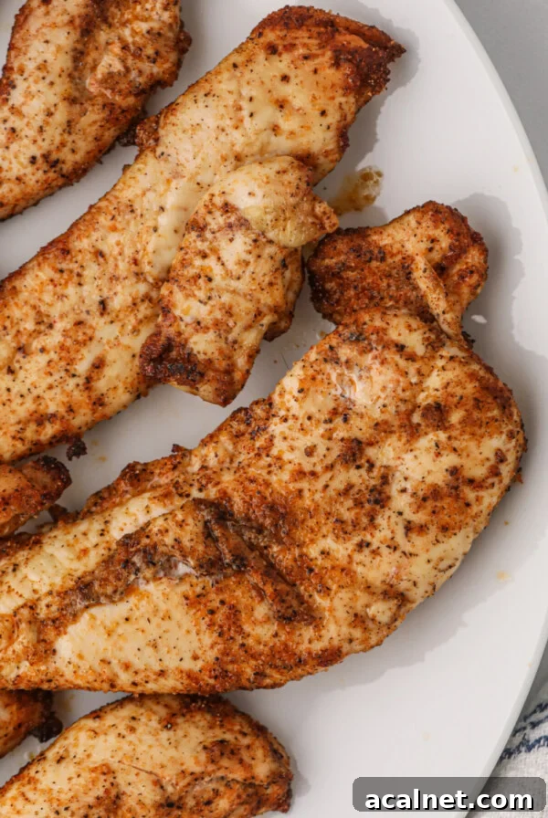 Air fryer grilled chicken tenders on a white plate.