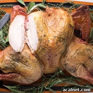 Spatchcocked Whole Turkey Smoked on a Traeger Grill 13 smoked turkey on a cutting board with a breast cut out