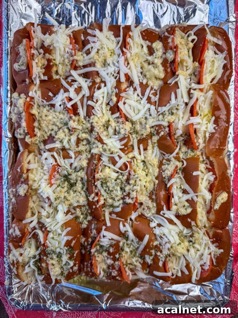 Melted butter with parmesan and garlic powder poured over top of pepperoni Hawaiian rolls.
