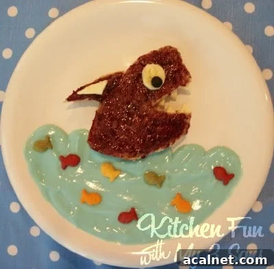 Lunch bread, yogurt and Goldfish crackers arranged on a plate to resemble an underwater scene
