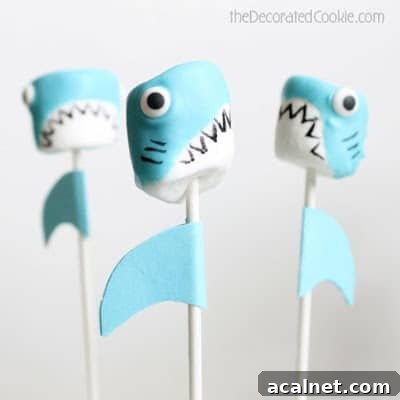 Three marshmallow shark pops with a plain white background