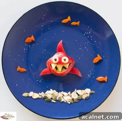 Various snack food items on a plate creating an underwater scene with a shark