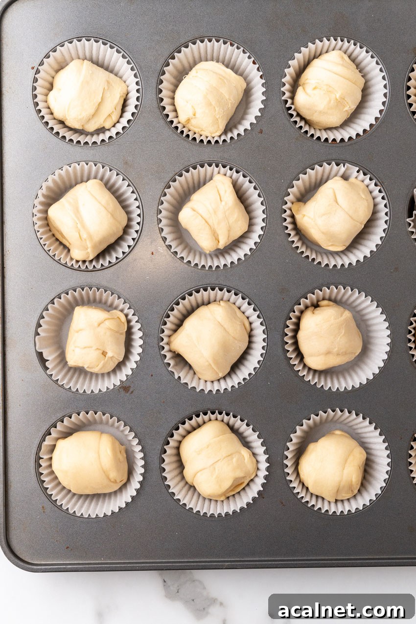 unbaked resurrection rolls in cupcake liners in a metal muffin pan