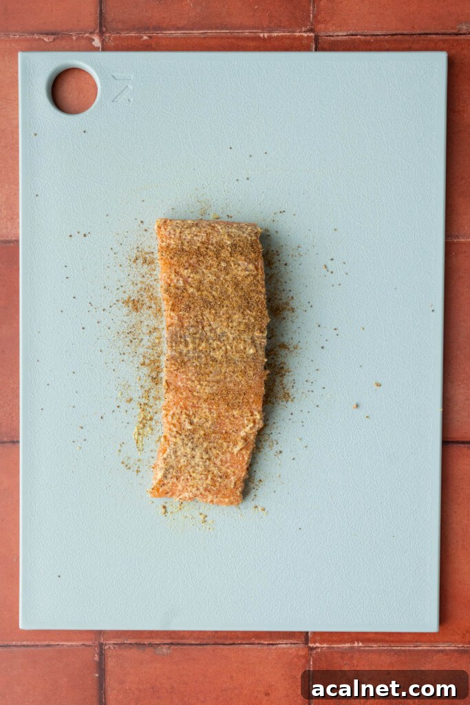 Skinless salmon with Dijon mustard and Old Bay seasoning on both sides.