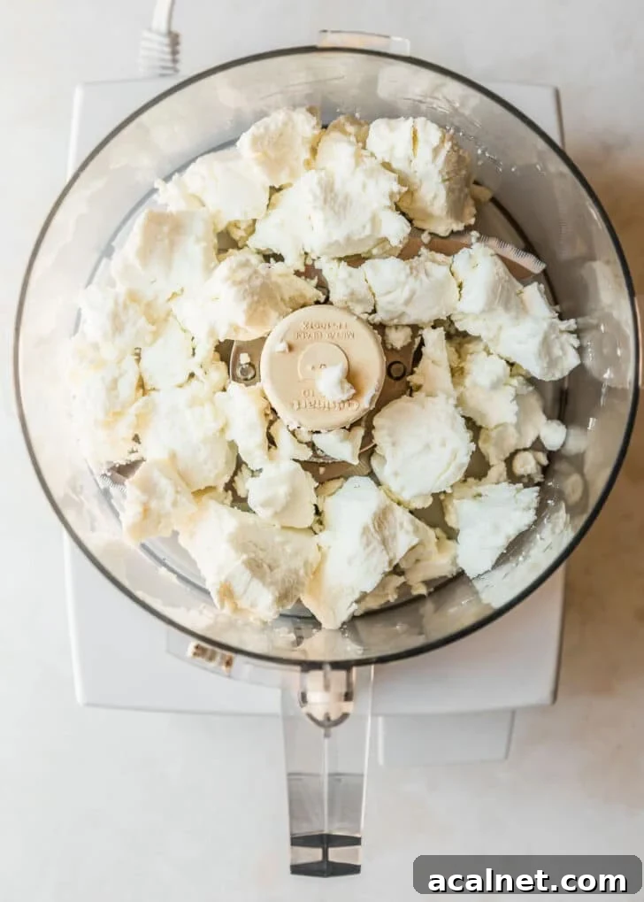 A food processor with goat cheese.