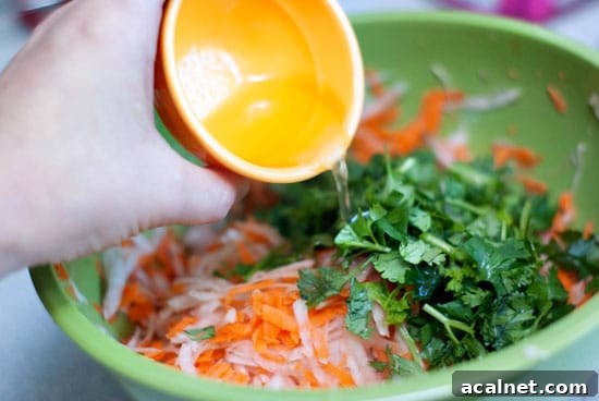 Pulled Pork Bánh Mì Sandwiches with Pickled Veggies and Herbs 6 Homemade Pulled Pork Sandwich ingredients in a green bowl.