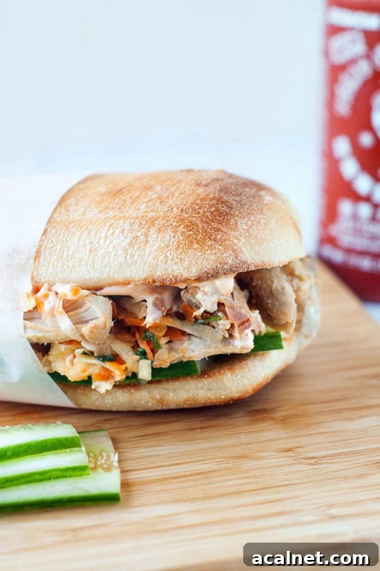 Pulled Pork Bánh Mì Sandwiches with Pickled Veggies and Herbs 8 From Scratch Korean Pulled Pork Sandwiches on a wooden board.