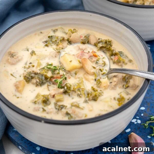 Creamy Roasted Butternut Squash and Tomato Soup Recipe 8 A bowl of crock pot zuppa toscana on a blue background.