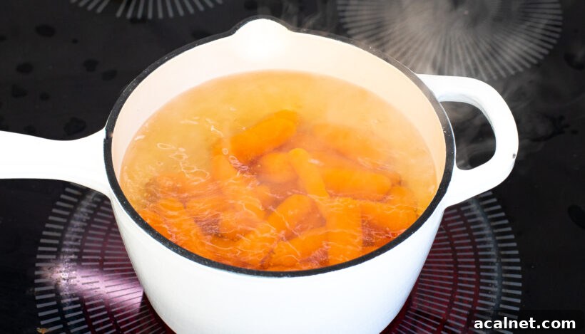 Carrots boiling in a saucepan. 