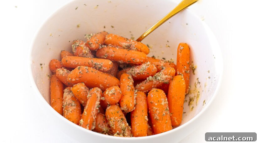 Carrots in a mixing bowl being coated in olive oil and ranch seasoning. 