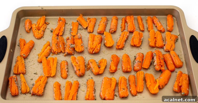Carrots smashed on a baking sheet. 