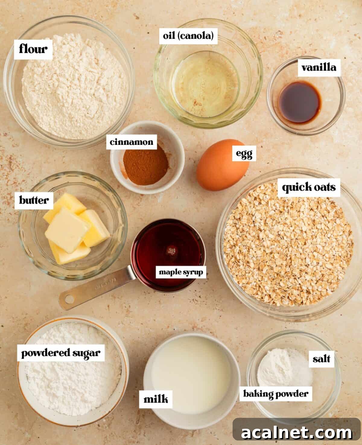 Quick cooking oats, flour, egg, cinnamon and other ingredients arranged on surface.